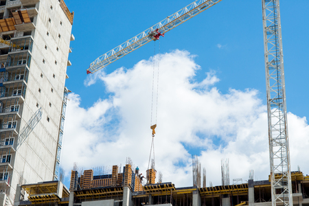 Tower crane on the construction of a residential houseの写真素材