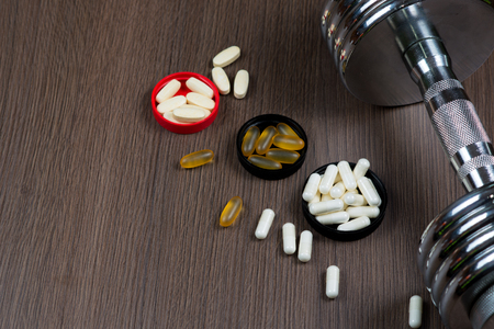 Sport, Fitness, sports nutrition in capsules on a wooden backgroundの写真素材