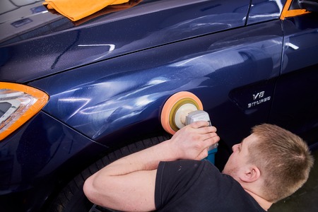 Moscow. Russia. May 29, 2018. A man polishes a blue Mercedes car ml.のeditorial素材