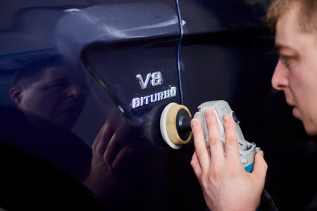 Moscow. Russia. May 29, 2018. A man polishes a blue Mercedes car ml.のeditorial素材