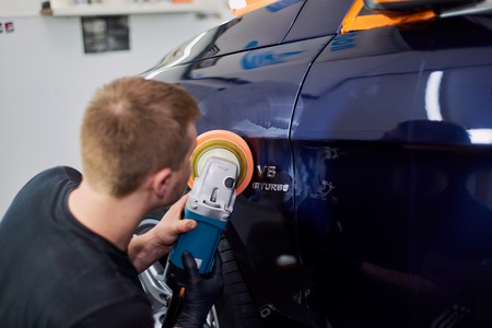 Moscow. Russia. May 29, 2018. A man polishes a blue Mercedes car ml.のeditorial素材