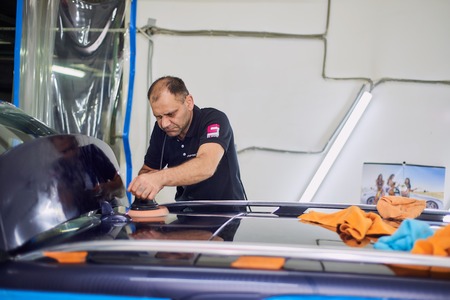 Moscow. Russia. May 29, 2018. A man polishes a blue Mercedes car ml.のeditorial素材