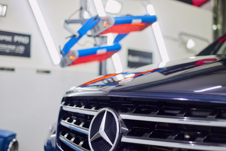 Moscow. Russia. May 30, 2018. A man polishes a blue Mercedes car ml.