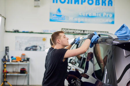 Moscow. Russia. May 30, 2018. A man polishes a blue Mercedes car ml.