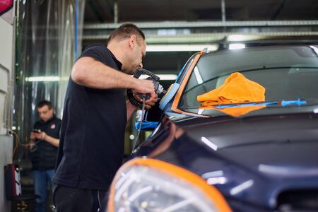 Moscow. Russia. May 29, 2018. A man polishes a blue Mercedes car ml.のeditorial素材