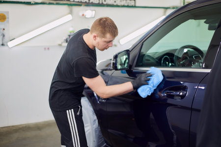 Moscow. Russia. May 29, 2018. A man polishes a blue Mercedes car ml.