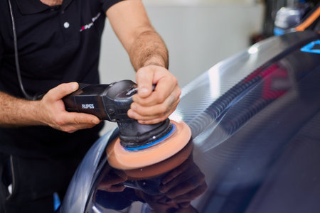 Moscow. Russia. May 29, 2018. A man polishes a blue Mercedes car ml.