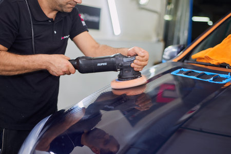 Moscow. Russia. May 29, 2018. A man polishes a blue Mercedes car ml.