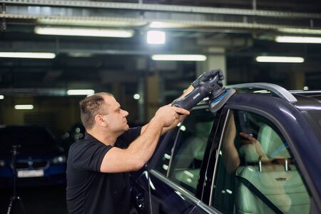 Moscow. Russia. May 29, 2018. A man polishes a blue Mercedes car ml.のeditorial素材