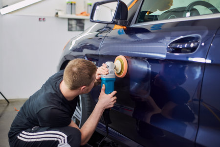 Moscow. Russia. May 29, 2018. A man polishes a blue Mercedes car ml.のeditorial素材