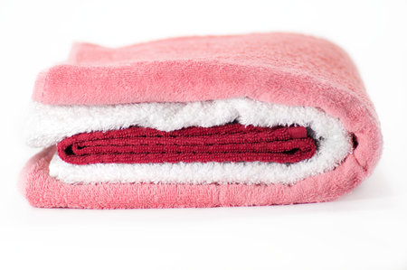 White, red and pink Terry towels isolated on white backgroundの写真素材