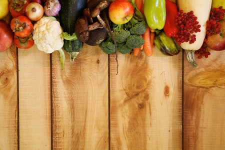 Frame New Harvest Autumn Yield with Vegetables, Fruits, Mushrooms and Berries closeup on Wooden backgroundの写真素材