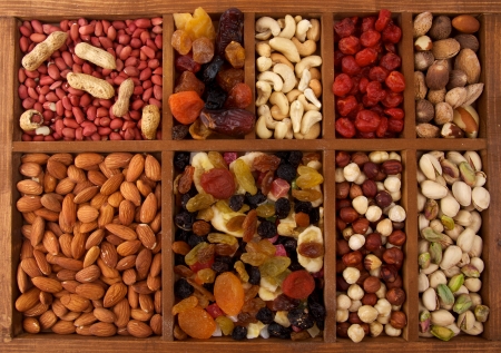 Arrangement of Dried Fruits and Nuts in Wooden Box closeup top viewの写真素材