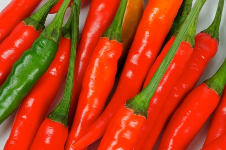 Perfect Red and One Green Chili Peppers Full Frame closeupの写真素材