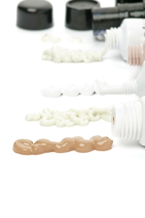 Facial Treatment Containers and Press out Cosmetics with BB-Cream, Mask, Soft Cleaner and Protection Gel closeup on white backgroundの写真素材