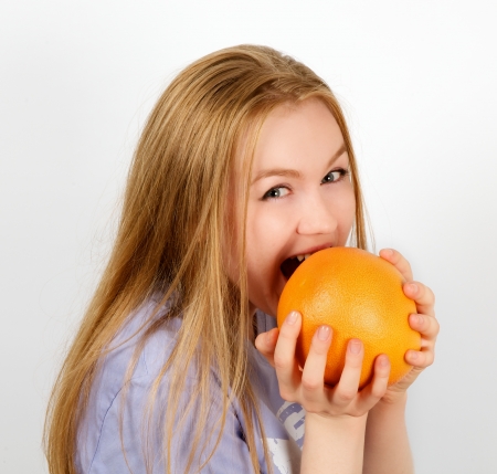 Portrait of Attractive Woman with Grapefruit closeup on white backgroundの写真素材