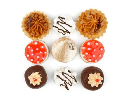 Arrangement of Chocolate Cupcakes,  Tartlet, Strawberry Jelly Cheesecake Polka Dot and Dark Chocolate Glazed Meringue isolated  on white background  Top Viewの写真素材
