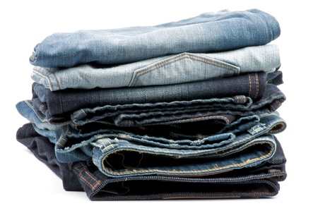 Stack of Folded New Dark and Light Blue Jeans isolated on white backgroundの写真素材