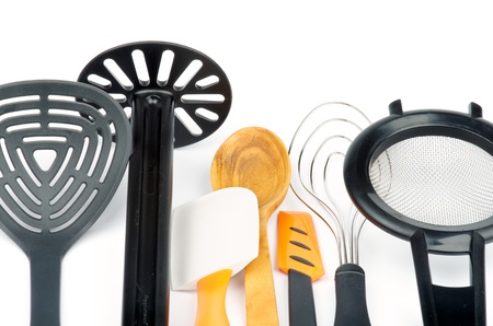 Set of Kitchen Utensils with Slotted Spoon, Potato Musher, Spatula, Wooden Spoon, Cream Spatula, Wire Whisk and Colander isolated on white backgroundの写真素材