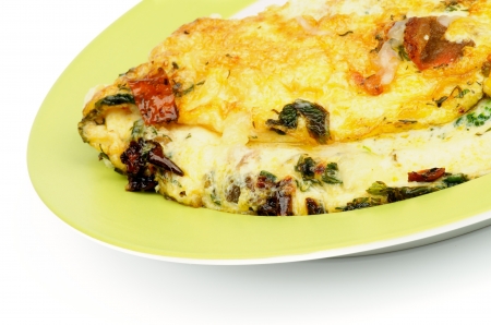 Delicious Omelet with Tomatoes, Parsley, Leek and Dill on Green Plate closeupの写真素材