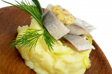 Delicious Snack of Piquant Herring on Mashed Potato with Dill, Spring Onion and Mustard on Wooden Plateの写真素材