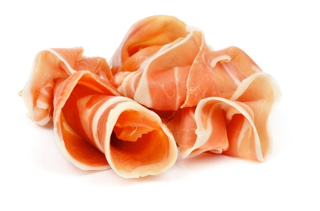 Curled Slices of Delicious Prosciutto isolated on white backgroundの写真素材