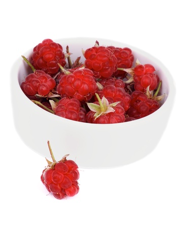 Juicy Raspberries with Fruit Stems in White Bowl isolated on white backgroundの写真素材