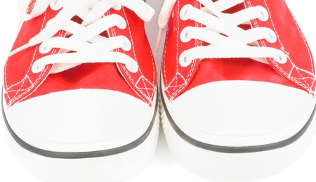 Noses of Trendy Red Gym Shoes closeup on white backgroundの写真素材
