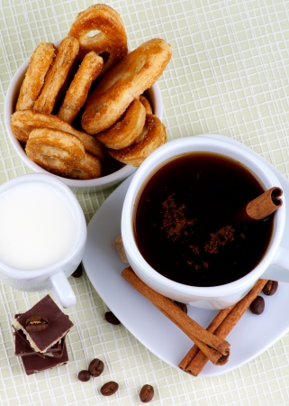 Arrangement of Coffee Cup, Milk and Puff Pastry with Chocolate, Sugar and Cinnamon Sticks  Top Viewの写真素材