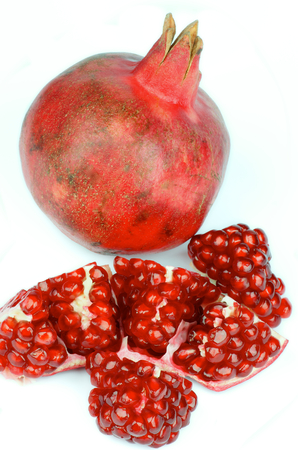 Big Ripe Pomegranate Full Body and Slices isolated on white backgroundの写真素材
