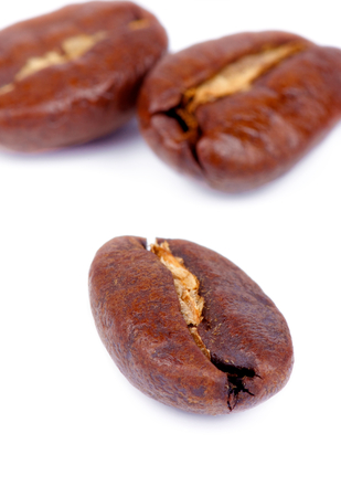 Three Perfect Roasted Coffee Beans isolated on white backgroundの写真素材