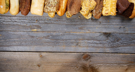 Frame of Various Buns, Baguette, Poppy Seed and Sesame Buns, Rye and Whole Wheat Bread closeup on...
