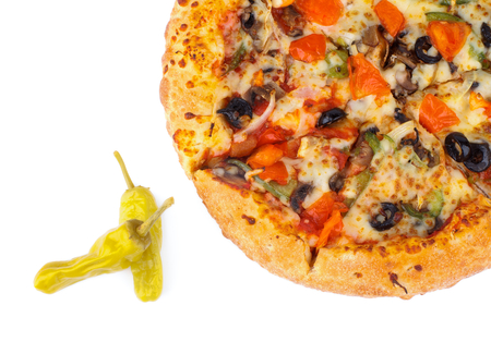Hot Vegetarian Pizza with Tomatoes, Black Olives and Two Jalapeno Peppers isolated on white background  Top Viewの写真素材
