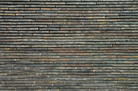 Background of Grey and Brown Plank Stone Exterior Wall closeupの写真素材