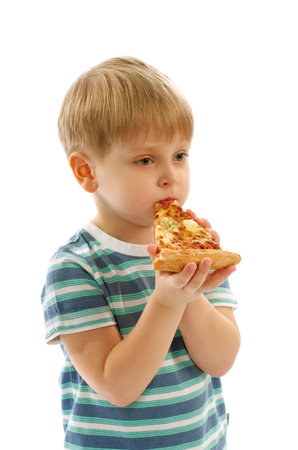 Cute Little Boy in Striped T-Short Eating Slice of Cheese Pizza isolated on white backgroundの写真素材