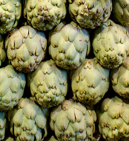 Background of Raw Ripe Artichokes Outdoors on Farmer Market Standの写真素材