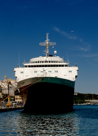 Luxury Giant Cruise Ship on Anchored in Port on Blue Sky background Outdoors. Port of Mahon Balearic Islandsの写真素材