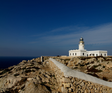 Lighthouse Far de Cavalleria on Blue Sky background on Mediterranean Shore of Menorca, Balearic Islandsの写真素材
