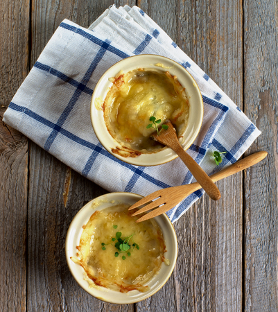 Ramekins with Delicious Champignon Mushroom on Checkered Napkin with Wooden Forks closeup Rustic Wooden background. Top Viewの写真素材