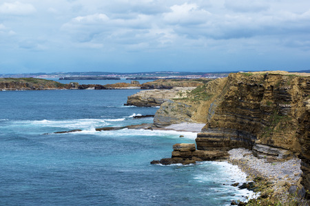 Atlantic Ocean Coastline with Cliffs and Harbors on Blue Cloudy Sky background Outdoors. Peniche, Portugalの写真素材