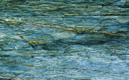 Background of Greenish Textured Shale Stone with Weathered Open-pit closeup Outdoors