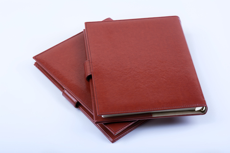 Red leather luxury diaries on white backgroundの写真素材