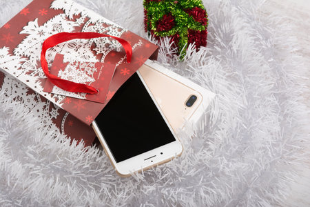 BURGAS, BULGARIA - OCTOBER 22, 2016: New Apple iPhone 7 Plus Gold on white background, Christmas gift, illustrative editorial.のeditorial素材