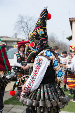 MEDOVO, BULGARIA - MARCH 17, 2018: People in traditional carnival masquerade costumes at Kukeri Festival, Medovo village near Burgas, Bulgaria.のeditorial素材