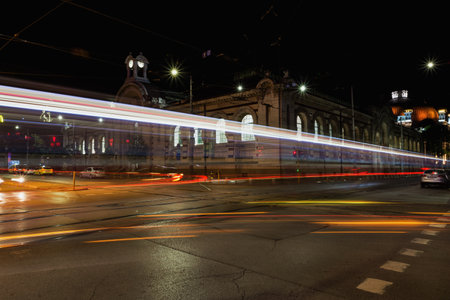 SOFIA, BULGARIA - MAY 8, 2018: Tsentralni Hali, Central Hali Market Hall, Halite, is a commercial complex in downtown of Sofia, Bulgaria. Night view with traffic light trails.のeditorial素材