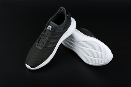 BURGAS, BULGARIA - MARCH 8, 2019: Adidas Women's Essentials Cloudfoam QT Flex Shoes Black on black background.のeditorial素材