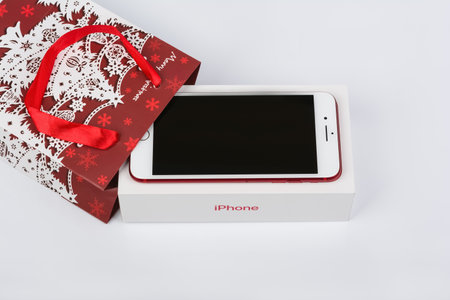 BURGAS, BULGARIA - DECEMBER 10, 2019: Apple iPhone 7 Plus Red Special Edition on white background, front side. Christmas gift.のeditorial素材