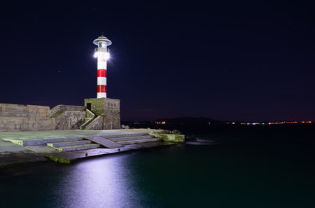 Lighthouse at night in Burgas port, Black Sea, Bulgaria.の写真素材