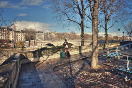 France, Paris - March 2008: A woman with a suitcase is waiting for someone on the Place Louis Aragonのeditorial素材