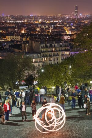 Spring 2008 - Paris. France: Paris at night and poi fire performance from a viewing point near the cathedral Sacre Coeurのeditorial素材